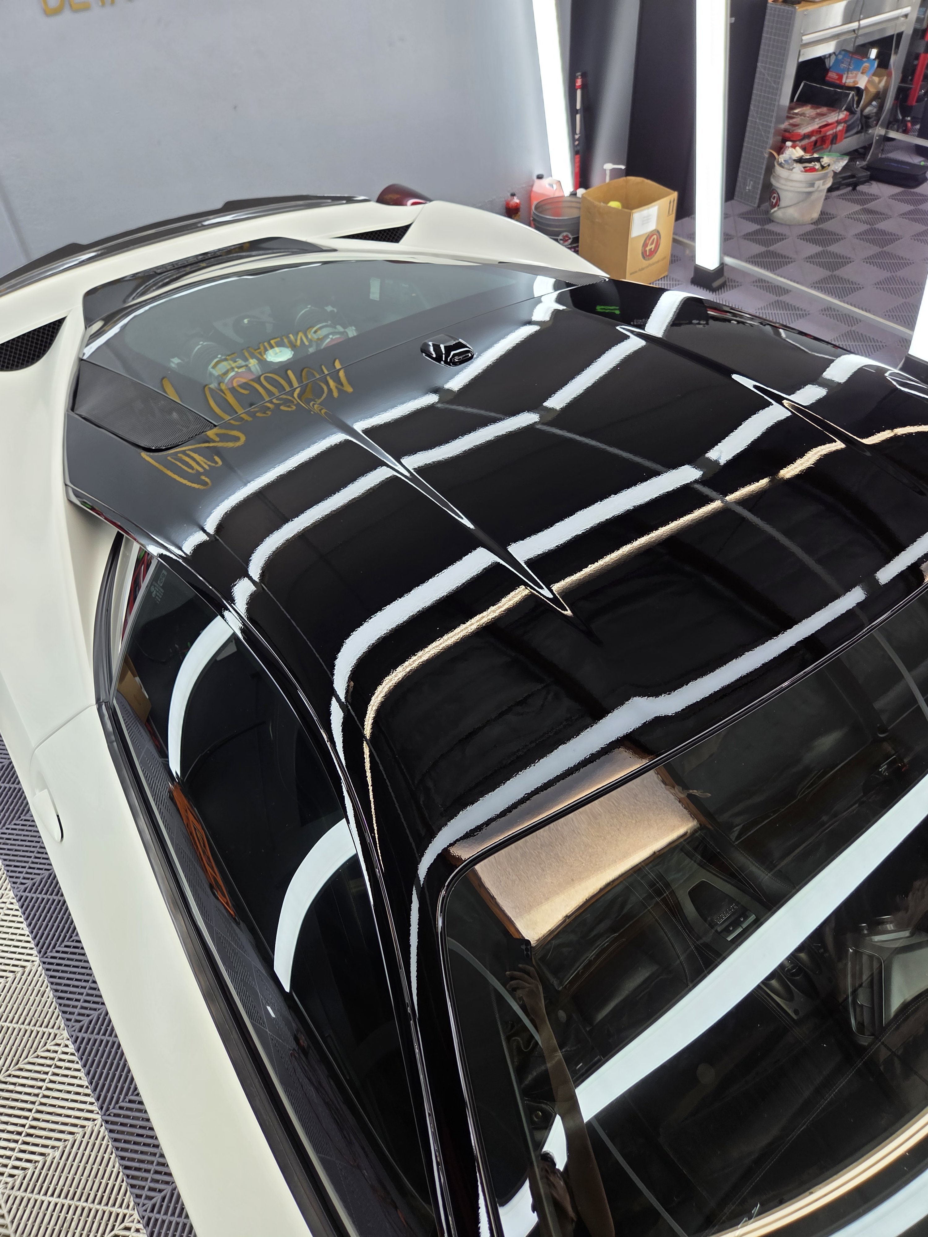 Detailer preparing a vehicle's paint surface before protection work